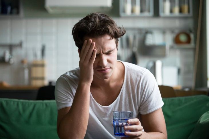 Feeling groggy in the morning, holding a cup of coffee to wake up without fatigue