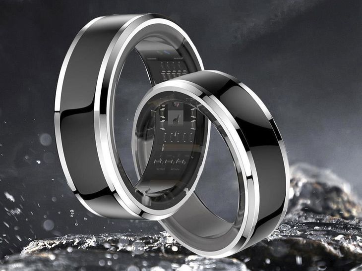A sleek waterproof smart ring resting on a wet poolside deck